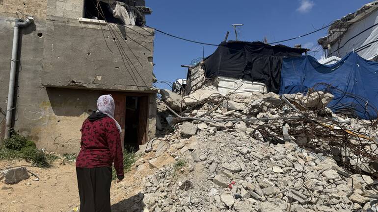 Eine Frau in Gaza vor Trümmern 